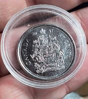 Reverse side of 2017 Canada 50-cent coin, coat of arms visible