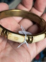 Side view of brass bangle showing ivory inlay segments