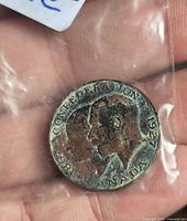 Obverse of 1927 Canadian Confederation medal showing dual busts and legend