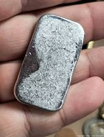 Front of pewter ingot showing crystalline texture