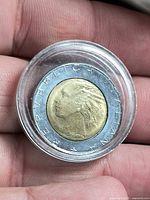 Obverse view showing brass center with female head, REPUBBLICA ITALIANA legend, encapsulated