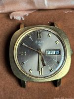 Front view of Elgin watch showing dial, indices and missing band