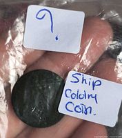 Token in plastic bag with handwritten label