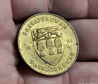 Obverse showing Saskatchewan shield with lion and wheat sheaves, dates 1905 and 1967