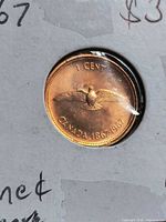Reverse of 1967 Canadian centennial one cent coin in 2x2 flip, dove design visible