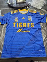 Front view of blue/yellow Adidas Tigres UANL soccer jersey with tags