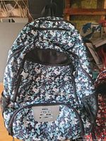 Front view of blue digital camo backpack showing compartments and mesh pockets