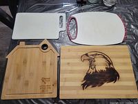 All four cutting boards laid out flat showing designs and condition