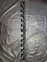 Full view of Easton black 12-slot fence-mount bat/arrow rack with carabiners