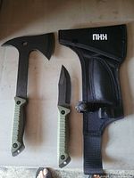 Hatchet, fixed blade knife and nylon sheath laid out