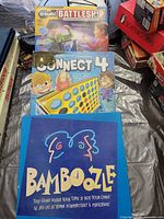 Front view of three board game boxes: u-Build Battleship, Connect 4, Bamboozle