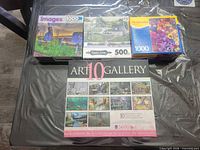 Four jigsaw puzzle boxes displayed on table