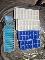 Top view showing two white cube trays, two blue cube trays, one teal stick tray and one blue freezer pack