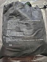 Front of black carry bag showing printed product details and partially visible green latex tubes
