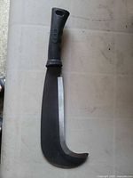 Full view of billhook machete showing blade shape and handle