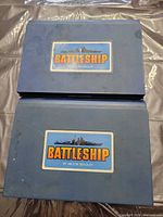 Two blue Milton Bradley Battleship game cases stacked