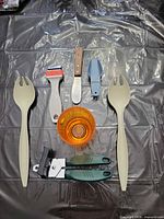 All seven kitchen utensils laid out on surface