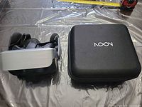 NOON VR headset and storage case on surface