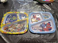 Front view of both divided plates showing graphics and compartment layout