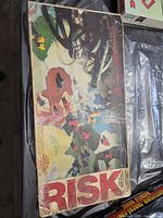 Top view of vintage Risk board game box showing artwork and heavy wear