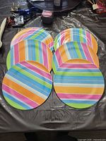 Six striped melamine dinner plates displayed face-up on a table