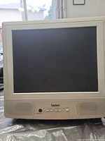 Front view of Symphonic beige CRT television showing screen, speaker grille, control buttons