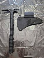 Tactical tomahawk and nylon sheath laid flat