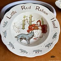 Front view of Little Red Riding Hood plate, second plate partially visible
