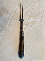 Full view of meat fork showing tines, handle, fittings