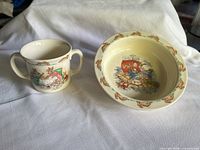 Mug and porringer side-by-side on white cloth