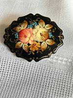 front view showing floral painting and scalloped shape