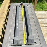Full view showing both crossbars side-by-side and tape measure indicating 46.5-inch width