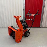 Left front three-quarter view of Ariens 520 snowblower showing housing, chute and wheels