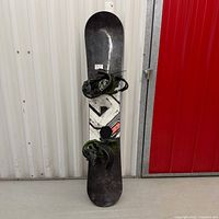 Full view of snowboard with mounted bindings