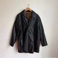 Front view of black leather Dockers coat on hanger