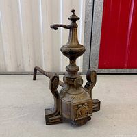 full view of andiron showing overall design and patina