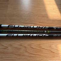 Side view of two Fujikura shafts showing model graphics and weights