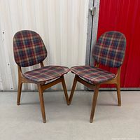 Pair of mid-century teak shield back chairs side by side