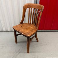 Front view of wooden chair showing overall design and wear