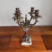 Front view showing full candelabra, four arms, marble base, crystal orb