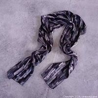 Full view of scarf loosely arranged to show size and drape