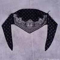Full view of black bandana-style top laid flat