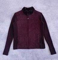 Full front view of brown faux suede jacket with knitted sleeves