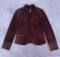 Full front view of brown suede jacket laid flat