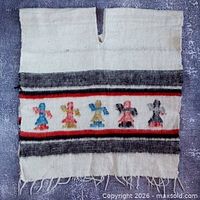 Full view of poncho showing pattern, slit neckline and fringe