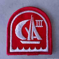 Front view of red sailing patch showing full embroidered design