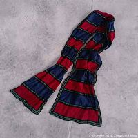 Full view of long striped scarf laid flat