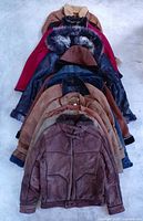 Stacked view of all 10 jackets showing variety of colours and materials