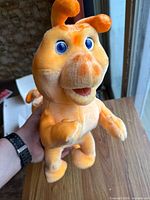 Front view of loose Grubby plush toy