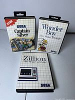 Front view of three Sega Master System game cases Captain Silver Wonder Boy Zillion